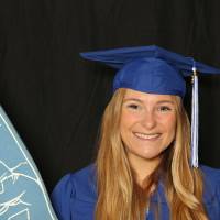 student at photobooth with foam finger